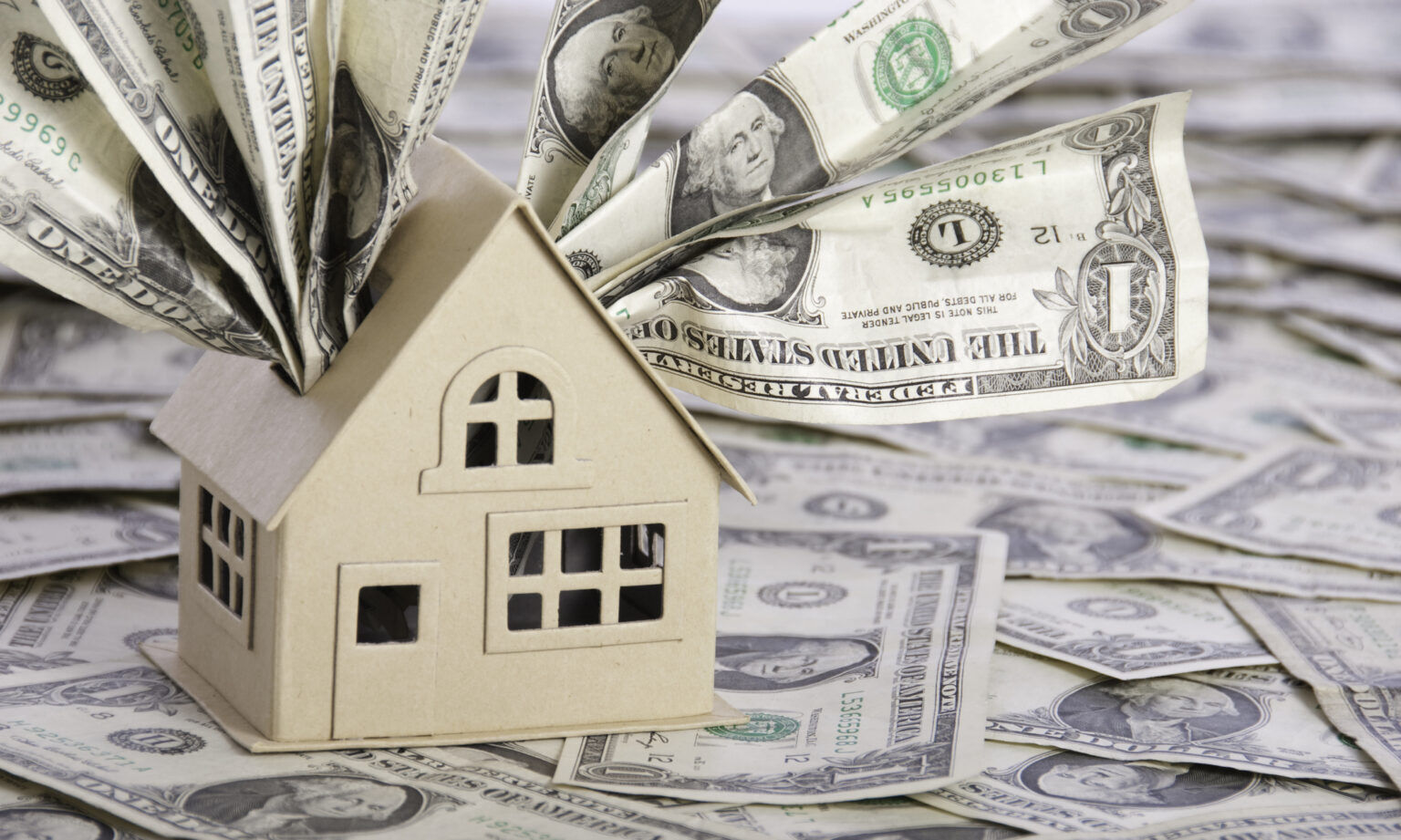 A model house with one dollar bills.